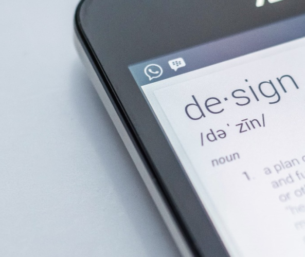 Mobile phone with the dictionary definition of design on the screen